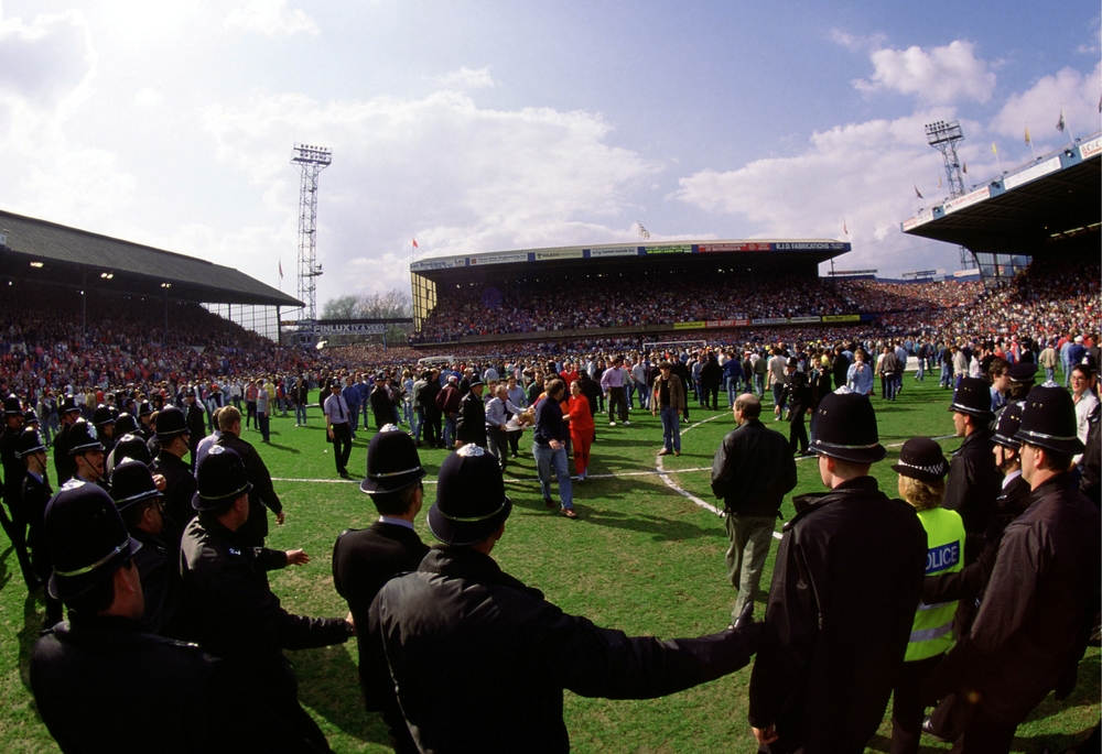 FILE PHOTO: Fans on the pitch during the disaster  / ACTION IMAGES