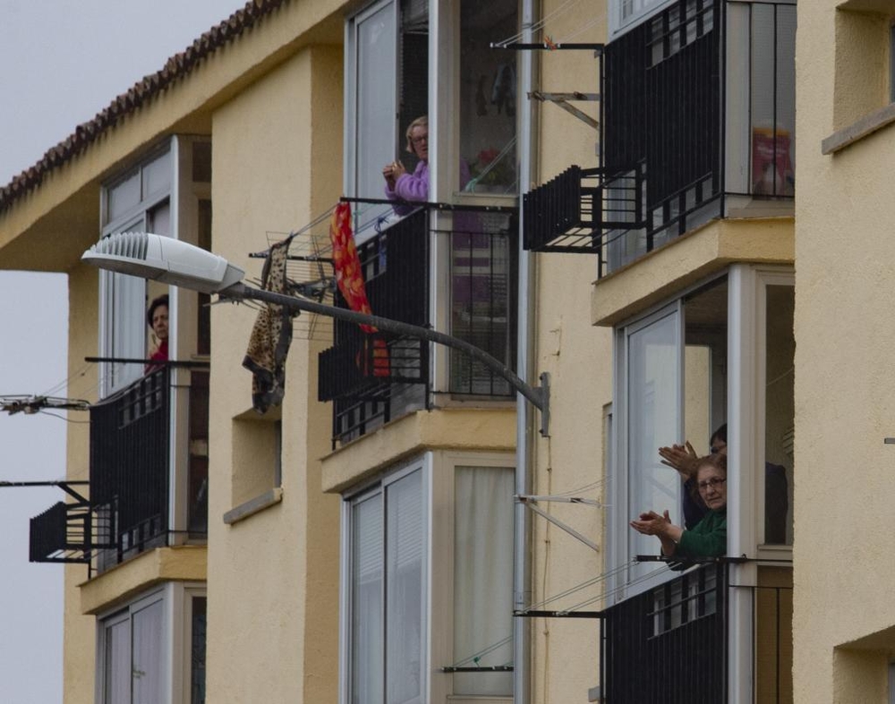 Puntuales a las ocho, los vecinos de El Teso salen a aplaudir junto a sus vecinos.  / DAVID CASTRO
